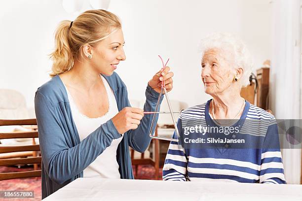 alzheimer therapy senior woman musical instrument - music therapy stock pictures, royalty-free photos & images