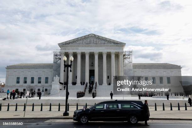 Former law clerks of retired Supreme Court Justice Sandra Day O'Connor watch as her casket is carried up the steps of the U.S. Supreme Court where...