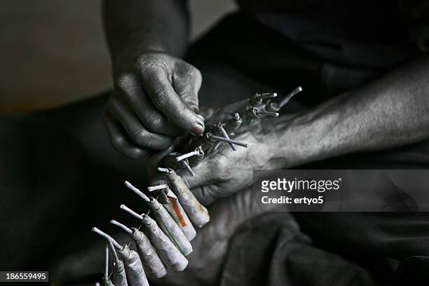sri lankan man makes fire crackers - gunpowder stock pictures, royalty-free photos & images