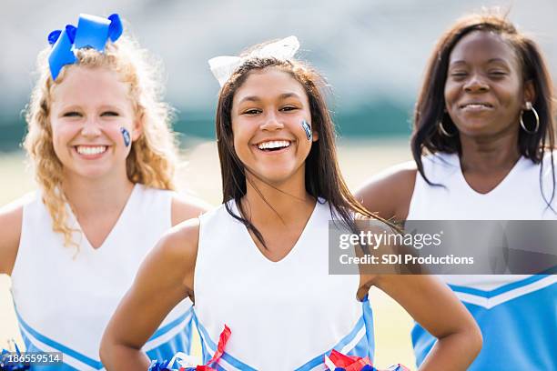 cute group of high school cheerleaders at football game - cheerleaders dance team stock pictures, royalty-free photos & images