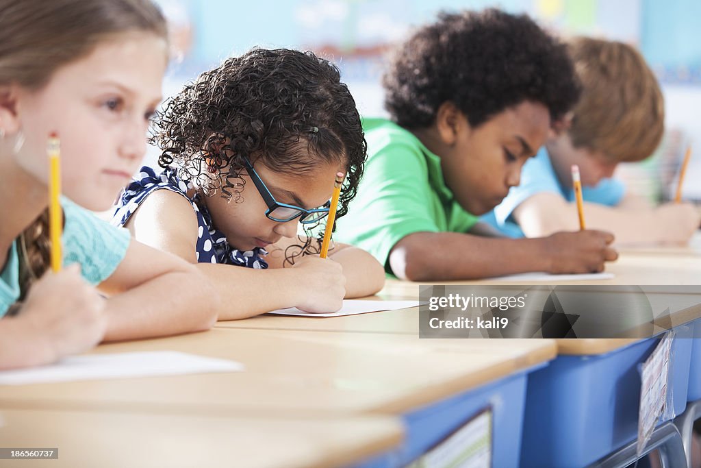 Elementary school children writing in class