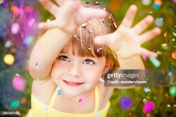 confetti falling on little girl - cute kids stockfoto's en -beelden