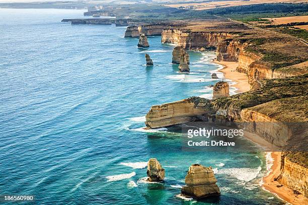 aerial view twelve apostles, port campbell national park at sunset - victoria aerial stock pictures, royalty-free photos & images