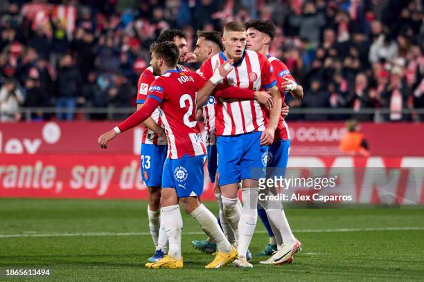 Artem Dovbyk of Girona FC celebrates with teammates after scoring their team's third goal with a penalty kick during the LaLiga EA Sports match...