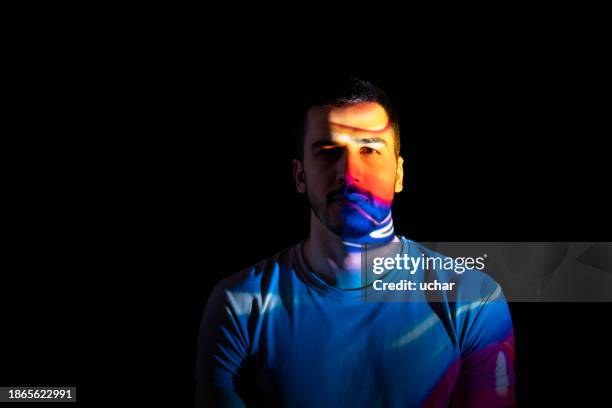 portrait of multicolored handsome man illuminated by neon lights - text face symbols stockfoto's en -beelden