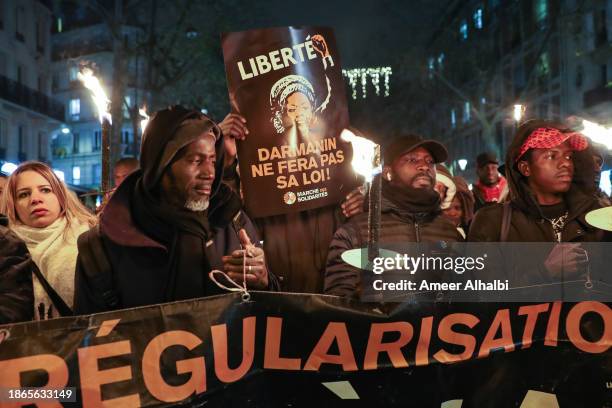 Hundreds of people gather to protest the controversial Darmanin Law on December 18, 2023 in Paris, France. More than 300 organizations joined a call...