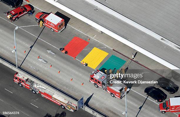 Los Angeles Fire Department personal wait to treat the injured at a staging area near Terminal 3 of Los Angeles International Airport November 1,...