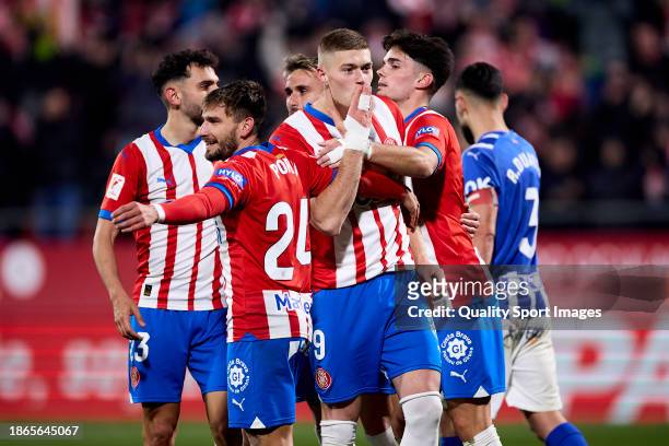 Artem Dovbyk of Girona FC celebrates after scoring their side's third goal with his teammate during the LaLiga EA Sports match between Girona FC and...