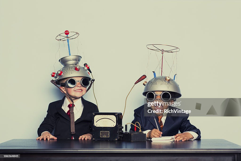 Boys Dressed as Businessmen Wearing Mind Reading Helmets
