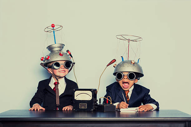 boys dressed as businessmen wearing mind reading helmets - kids stock pictures, royalty-free photos & images