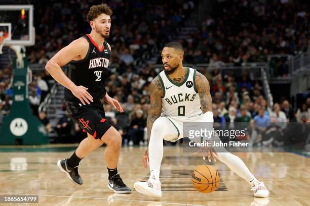 Damian Lillard of the Milwaukee Bucks drives to the basket against Alperen Sengun of the Houston Rockets during the first half of the game at Fiserv...