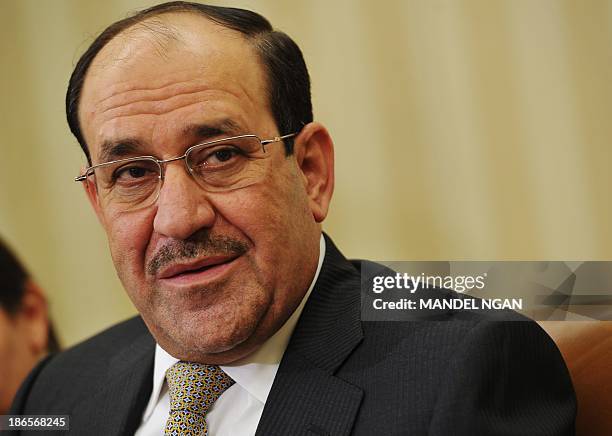 Iraqi Prime Minister Nuri al-Maliki speaks during a meeting with US President Barack Obama during a meeting in the Oval Office of the White House on...