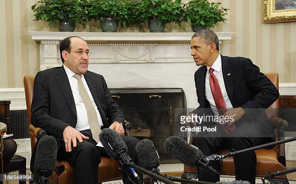 Iraqi Prime Minister Nouri Al-Maliki speaks with U.S. President Barack Obama in the Oval Office at the White House November 1, 2013 in Washington,...