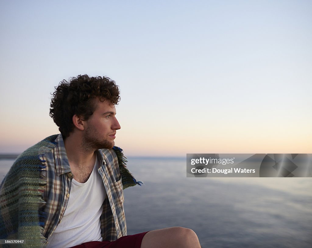 Man sitting and looking out to sea.