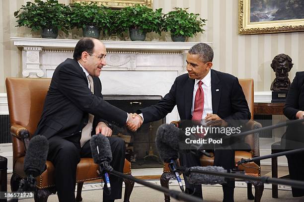 Iraqi Prime Minister Nouri Al-Maliki shakes hands with U.S. President Barack Obama in the Oval Office at the White House November 1, 2013 in...