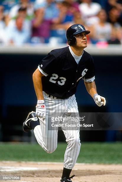 Robin Ventura of the Chicago White Sox puts the ball in play and runs towards first base during an Major League Baseball game circa 1992 at Comiskey...