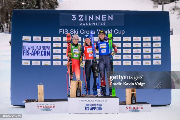 Second placed Fanny Smith of Switzerland, first placed Sandra Naeslund of Sweden and third placed Hannah Schmidt of Canada celebrates at the award...