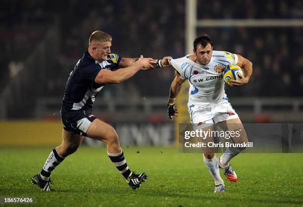 Dan Braid of Sale Sharks tackles Luke Arscott of Exeter Chiefs during the Aviva Premiership match between Sale Sharks and Exeter Chiefs at the AJ...