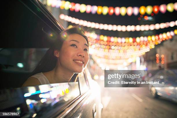 chinese woman in car looking at lanterns - singapore fotografías e imágenes de stock