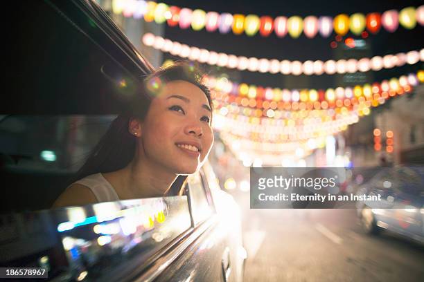 chinese woman in car looking at lanterns - singapore stock pictures, royalty-free photos & images