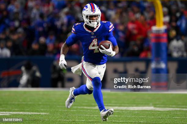 James Cook of the Buffalo Bills runs with the ball against the Dallas Cowboys during the second half at Highmark Stadium on December 17, 2023 in...