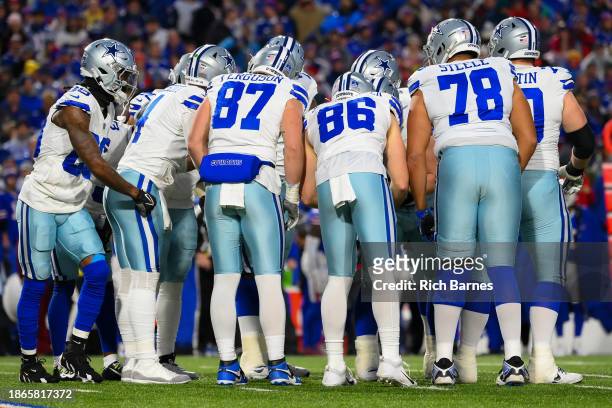Dallas Cowboys players huddle against the Buffalo Bills during the first half at Highmark Stadium on December 17, 2023 in Orchard Park, New York. The...