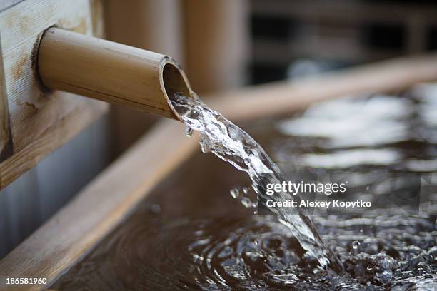 water flowing at an onsen - hot springs stock-fotos und bilder