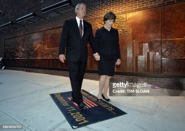 President George W. Bush and First Lady Laura Bush hold hands after making a statment to the press on the fifth anniversary of the 11 September 2001...