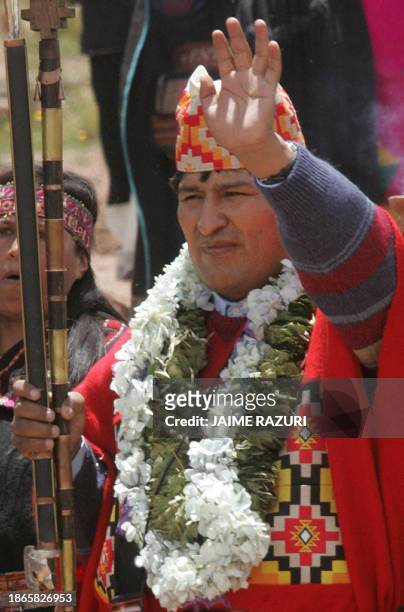 Bolivia's President-elect Evo Morales waves after a ritual performed by four Amautas during an elaborate ceremony where he was crowned as supreme...