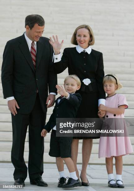 Chief Justice John G. Roberts Jr stands with his wife Jane while outside the Supreme Court with his son Jack and daughter Josie, 03 October, 2005 in...