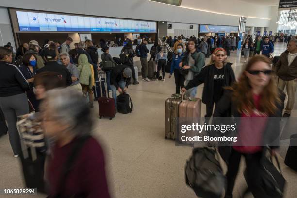 Travelers wait to check in at the American Airlines ticket counter at San Francisco International Airport in San Francisco, California, US, on...