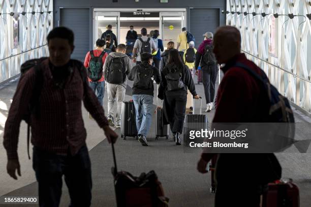 Travelers at San Francisco International Airport in San Francisco, California, US, on Thursday, Dec. 21, 2023. An estimated 112.7 million people will...