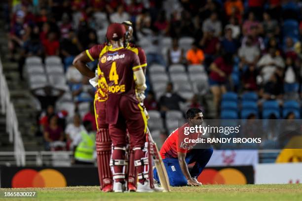 Rehan Ahmed of England dries his hands during the 5th T20I between the West Indies and England at Brian Lara Cricket Academy Stadium in Tarouba,...