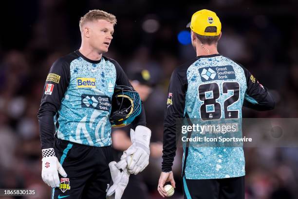 Brisbane Heat players Sam Billings and Captain Colin Munro during KFC Big Bash League T20 match between Melbourne Renegades and Brisbane Heat at the...