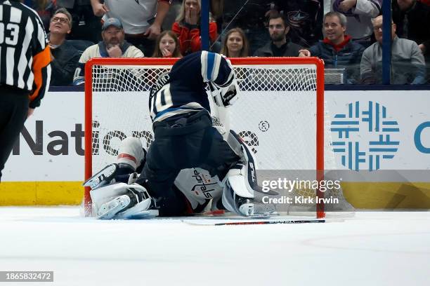 Elvis Merzlikins of the Columbus Blue Jackets punches Tom Wilson of the Washington Capitals during overtime at Nationwide Arena on December 21, 2023...