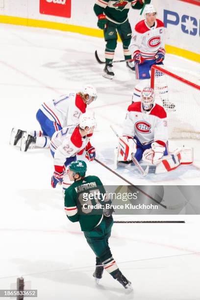 Kirill Kaprizov of the Minnesota Wild scores the game winning goal in overtime against Cole Caufield, Kaiden Guhle and Sam Montembeault of the...