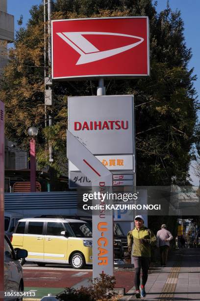 This picture shows signboards of Daihatsu Motor displayed at its sales office in Tokyo on December 22, 2023.