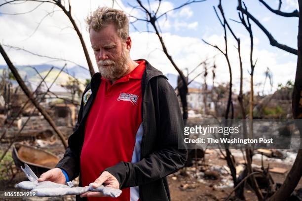 Lahaina, HI Sen. Angus McKelvey holds a melted aluminum piece he retrieved from his car, melted during August's wildfire in Lahaina, Hawaii on...