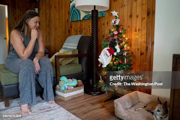 Lahaina, HI Amy Chadwick looks at ornaments her children made after losing their home and most of their belongings in August's wildfire at her...