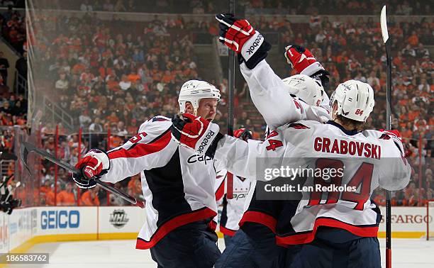 Jason Chimera, Joel Ward, and Mikhail Grabovski of the Washington Capitals celebrate Chimera's second period goal against the Philadelphia Flyers on...