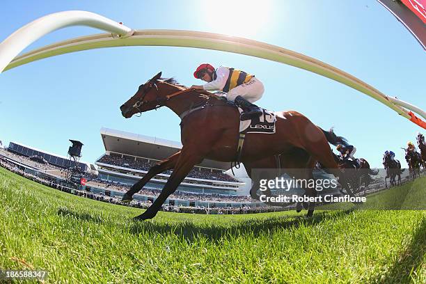 Kerrin McEvoy riding Ruscello crosses the line to win race three the Lexus Stakes during Derby Day at Flemington Racecourse on November 2, 2013 in...