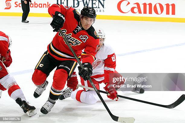 Michael Cammalleri of the Calgary Flames skates against Justin Abdelkader of the Detroit Red Wings at Scotiabank Saddledome on November 1, 2013 in...