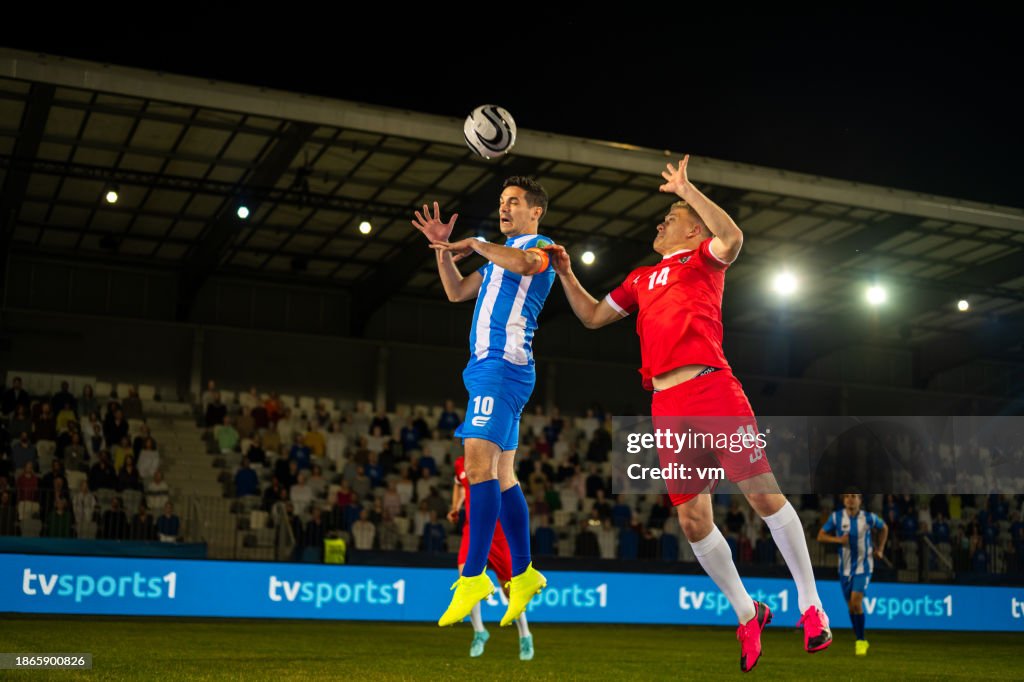 Male soccer players jumping