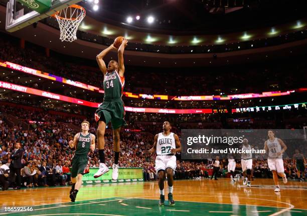 Giannis Antetokounmpo of the Milwaukee Bucks dunks the ball in front of Jordan Crawford of the Boston Celtics in the second half during the home...