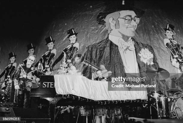 English singer-songwriter Elton John performing on stage during his Christmas show at the Hammersmith Odeon, London, 21st December 1973.