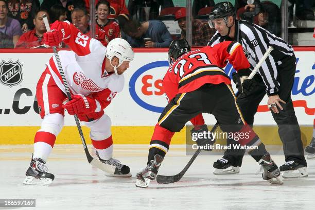 Sean Monahan of the Calgary Flames faces off against Johan Franzen of the Detroit Red Wings at Scotiabank Saddledome on November 1, 2013 in Calgary,...