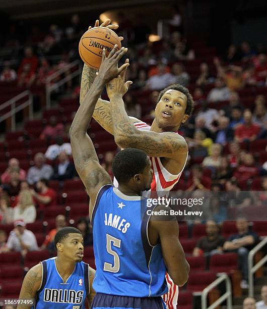 Greg Smith of the Houston Rockets shoots over Bernard James of the Dallas Mavericks in the fourth quarter at Toyota Center on November 1, 2013 in...