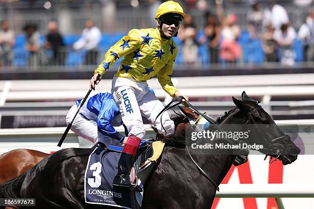 Jamie Spencer riding Side Glance wins race 5 the Longines Mackinnon Stakes during Derby Day at Flemington Racecourse on November 2, 2013 in...