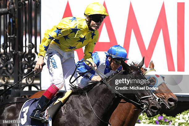 Jamie Spencer riding Side Glance defeats Chris Munce riding Dear Demi to win race 5 the Longines Mackinnon Stakes during Derby Day at Flemington...