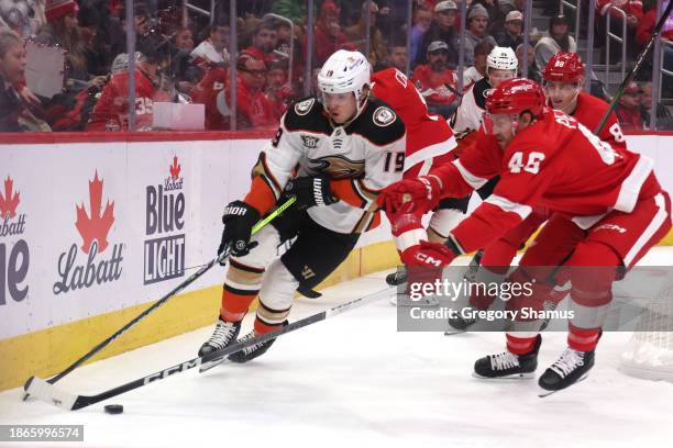 Troy Terry of the Anaheim Ducks tries to get around the stick of Jeff Petry of the Detroit Red Wings during the first period at Little Caesars Arena...